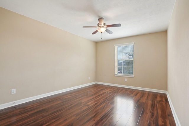 empty room featuring ceiling fan, baseboards, and dark wood finished floors