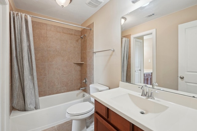 bathroom featuring visible vents, vanity, toilet, and tile patterned floors