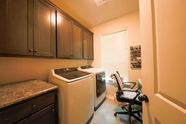 laundry room with cabinets and washing machine and dryer
