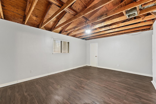 basement featuring dark hardwood / wood-style flooring