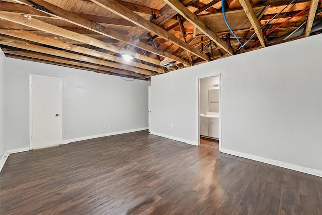 basement with dark hardwood / wood-style flooring