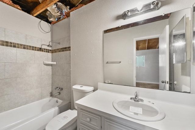 full bathroom featuring vanity, tiled shower / bath combo, and toilet