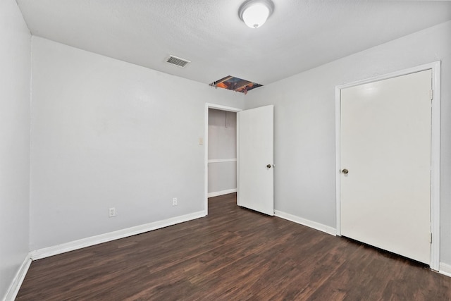 unfurnished bedroom with dark hardwood / wood-style floors