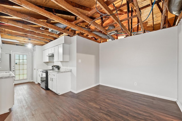 kitchen featuring electric range oven, sink, white cabinets, light stone counters, and dark wood-type flooring