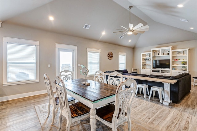 dining area featuring vaulted ceiling, light hardwood / wood-style floors, and ceiling fan