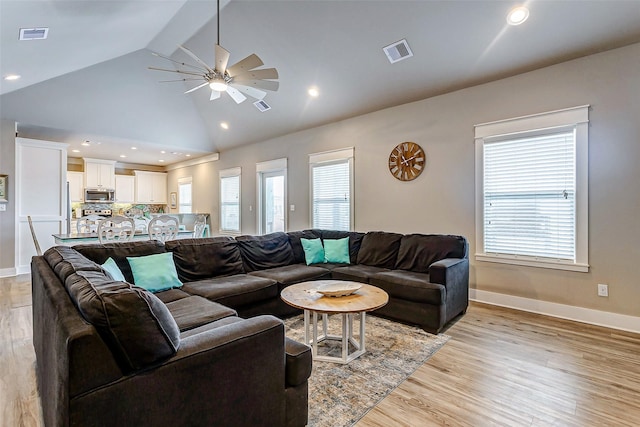 living room with beamed ceiling, ceiling fan, high vaulted ceiling, and light wood-type flooring