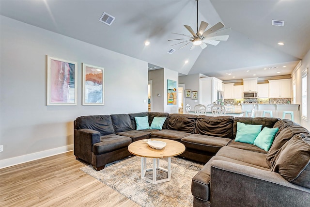 living room with high vaulted ceiling, light hardwood / wood-style floors, and ceiling fan