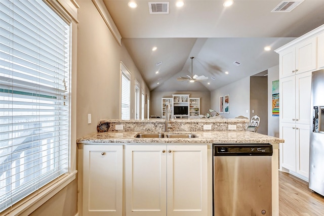 kitchen featuring stainless steel appliances, light stone countertops, sink, and white cabinets