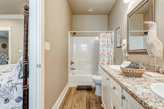 full bathroom featuring hardwood / wood-style flooring, vanity, toilet, and shower / bath combo