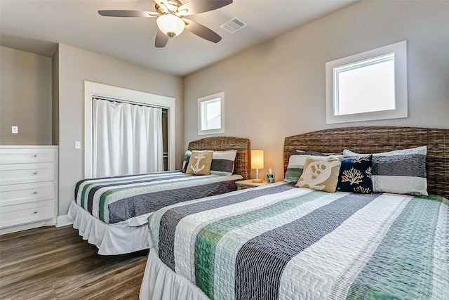 bedroom with dark hardwood / wood-style flooring and ceiling fan