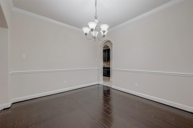 unfurnished room featuring ornamental molding, dark hardwood / wood-style floors, and an inviting chandelier