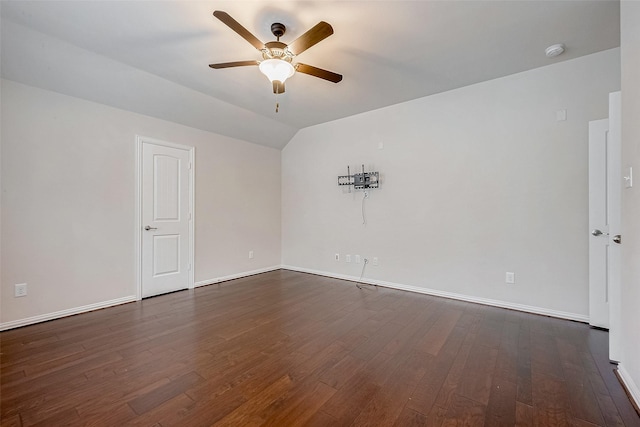 spare room with lofted ceiling, dark wood-type flooring, and ceiling fan