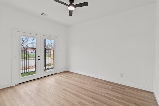 spare room with french doors, ceiling fan, and light wood-type flooring