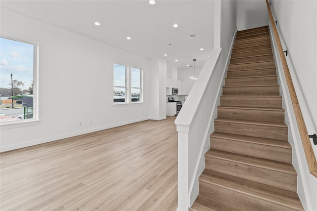 stairway featuring wood-type flooring