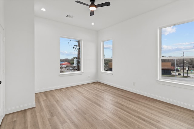 spare room featuring ceiling fan and light hardwood / wood-style flooring