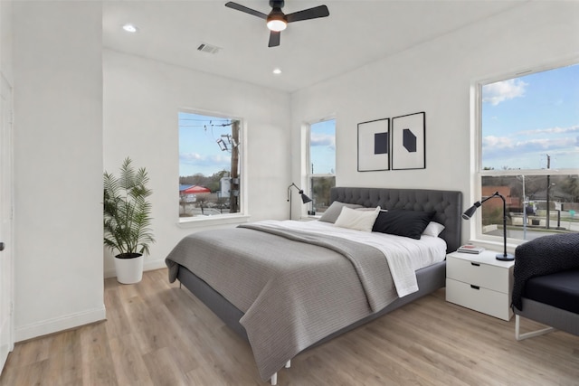 bedroom with ceiling fan and light wood-type flooring