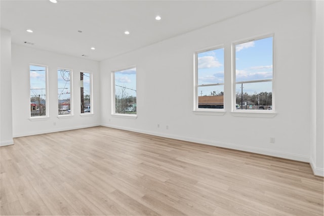 spare room with light hardwood / wood-style flooring