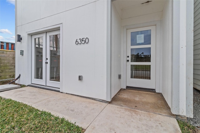 view of exterior entry featuring a patio and french doors