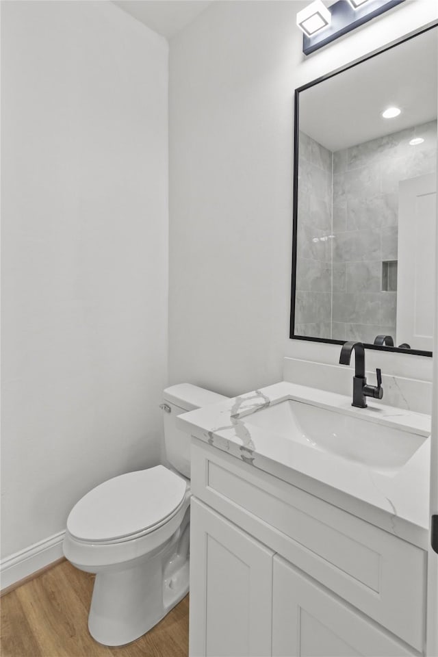 bathroom with vanity, hardwood / wood-style floors, and toilet