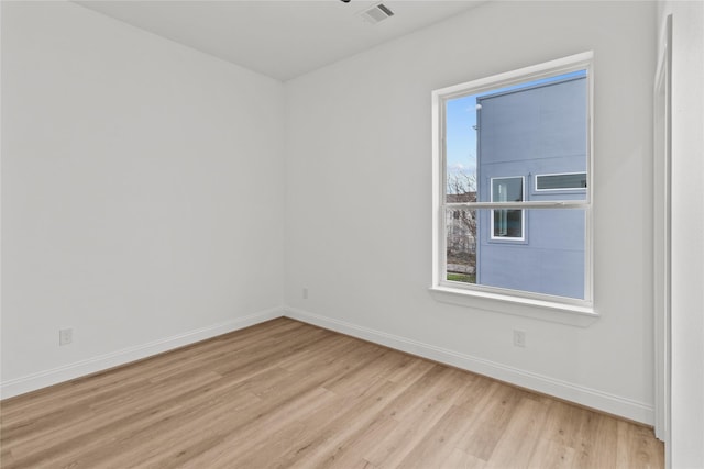 empty room with light hardwood / wood-style flooring