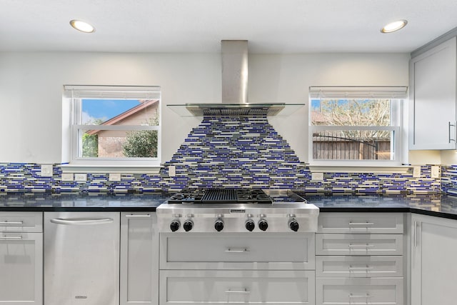 kitchen featuring white cabinetry, stainless steel gas cooktop, backsplash, and wall chimney exhaust hood