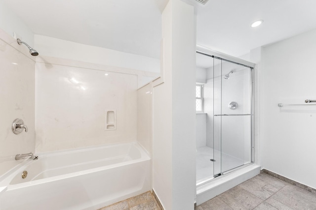 bathroom featuring shower with separate bathtub