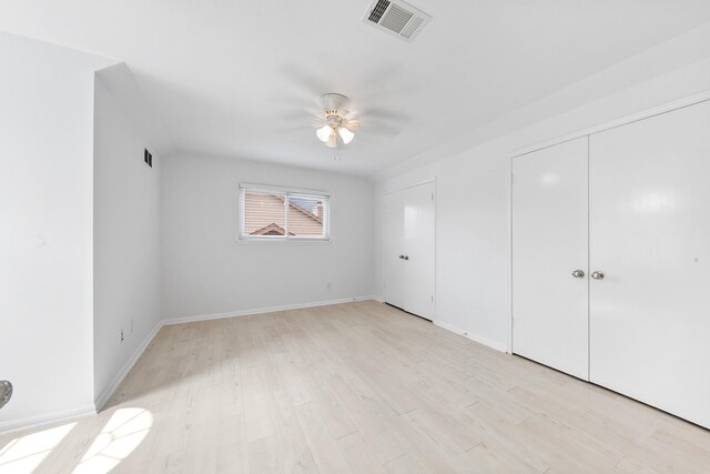 unfurnished bedroom with ceiling fan and light hardwood / wood-style floors