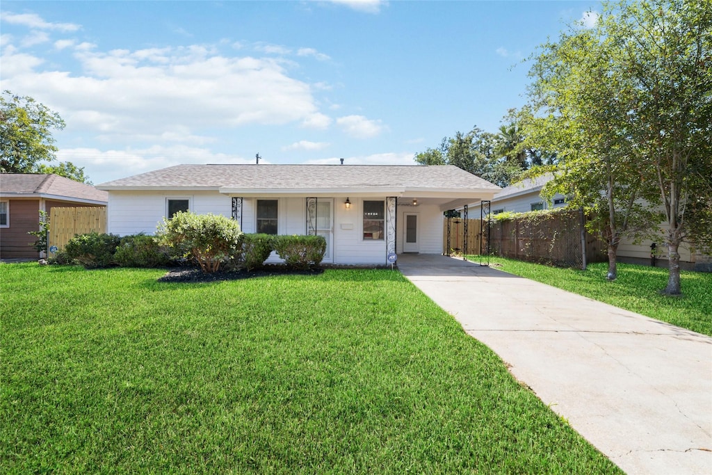 ranch-style house with a front lawn and a carport