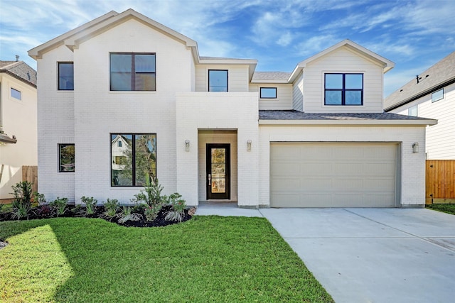 view of front of house with a garage and a front lawn