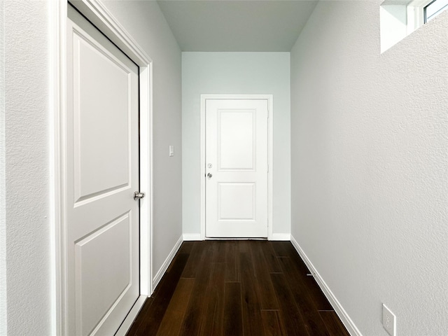 hall with dark wood-type flooring