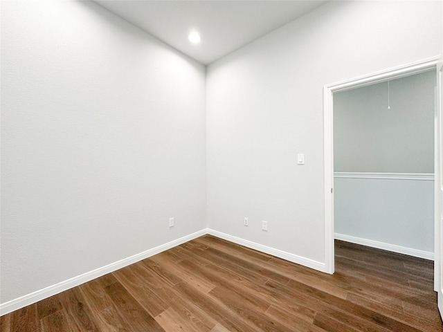 unfurnished room with hardwood / wood-style flooring