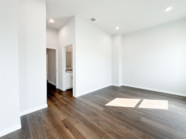 unfurnished room featuring dark wood-type flooring