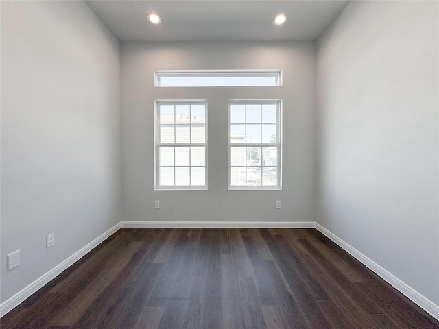 spare room with dark hardwood / wood-style flooring