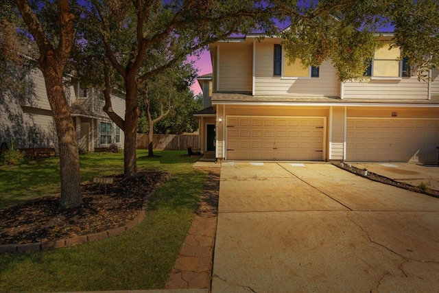 view of front of home featuring a garage and a yard