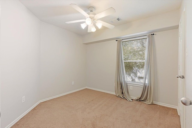 carpeted empty room featuring ceiling fan