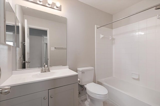 full bathroom with vanity, tiled shower / bath, and toilet