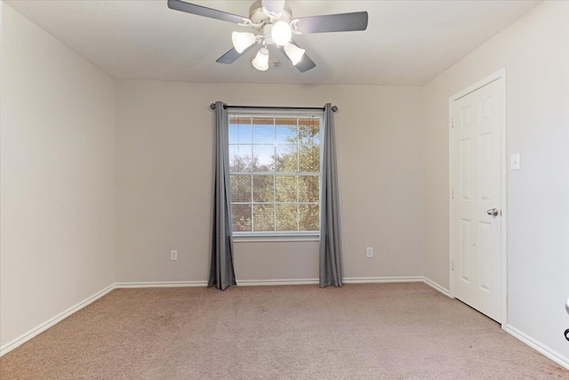 empty room featuring light colored carpet and ceiling fan