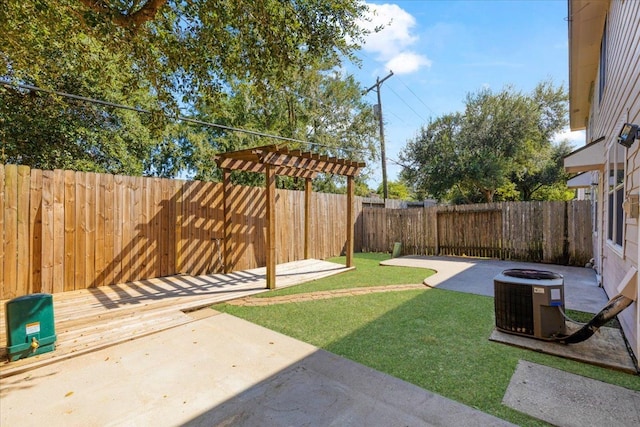 view of yard with central AC unit, a fire pit, and a patio area