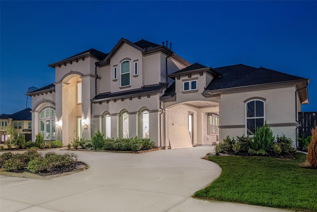 mediterranean / spanish-style home featuring a front yard