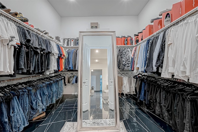 spacious closet with dark tile patterned flooring