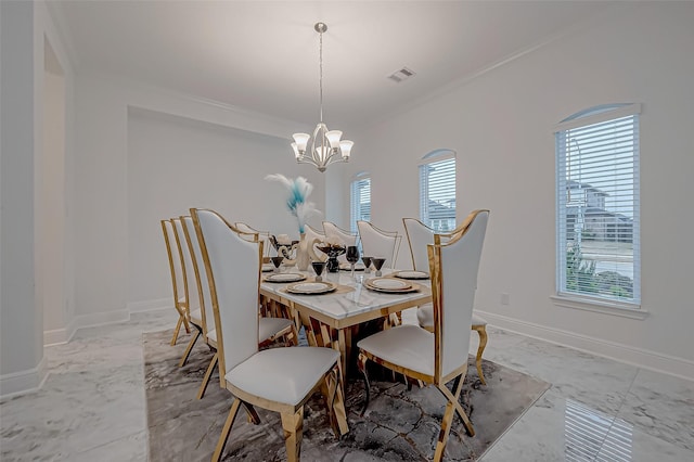 dining area featuring ornamental molding and a notable chandelier