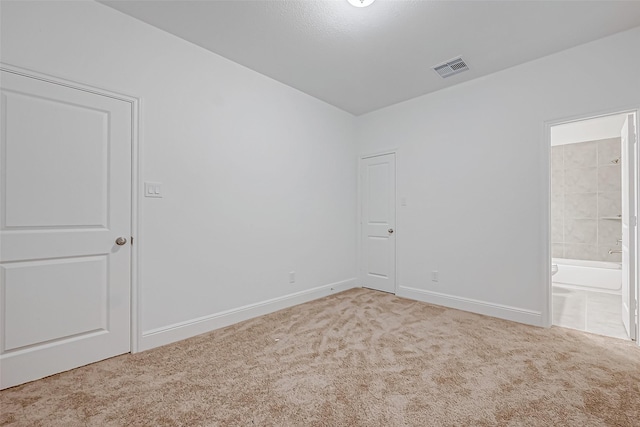 empty room featuring light colored carpet