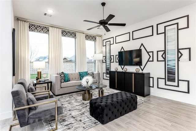 living room featuring ceiling fan and light wood-type flooring