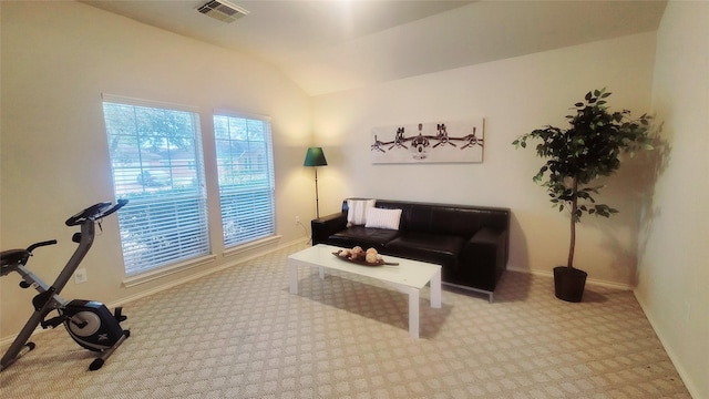 carpeted living room with lofted ceiling