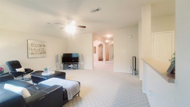 carpeted living room with ceiling fan