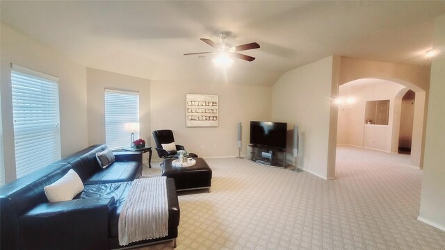 carpeted living room featuring vaulted ceiling and ceiling fan