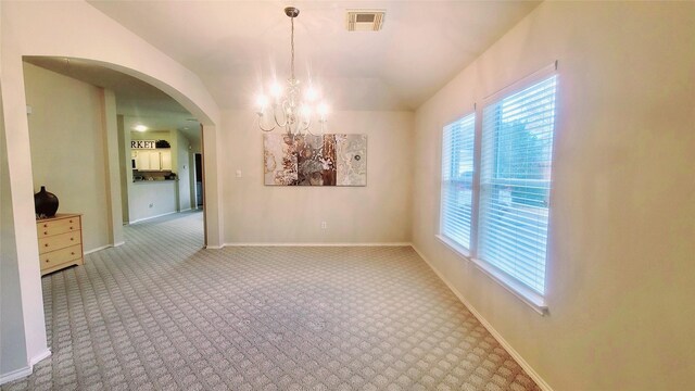 unfurnished dining area featuring carpet floors and a chandelier