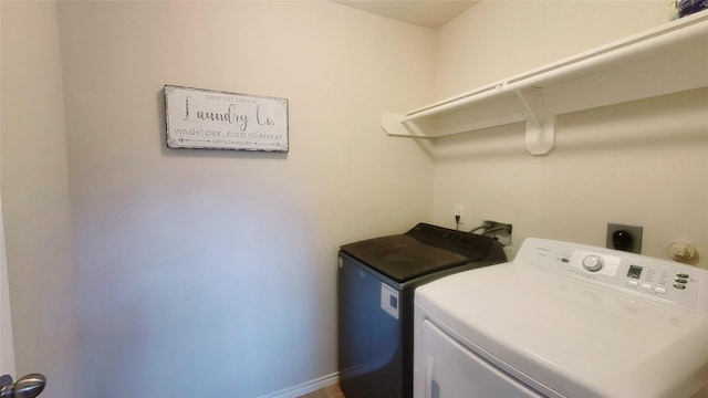 clothes washing area with washer and dryer