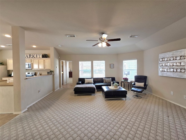 living room with light colored carpet and ceiling fan