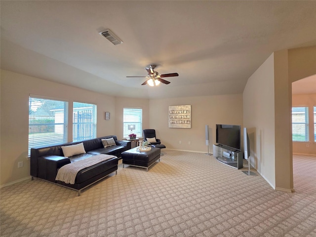 carpeted living room with ceiling fan